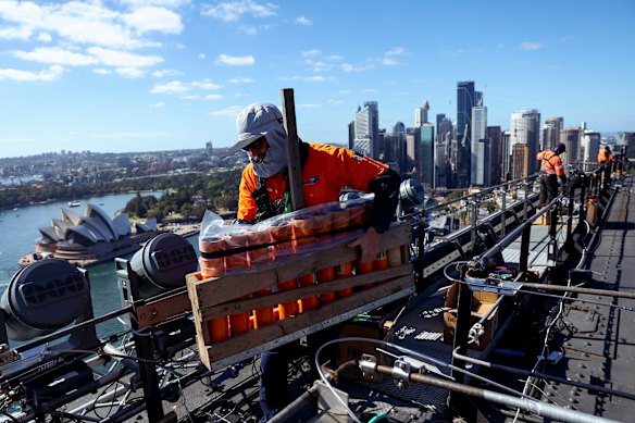 Workers are spaced five to 10 metres apart to pass equipment in a “production line”.