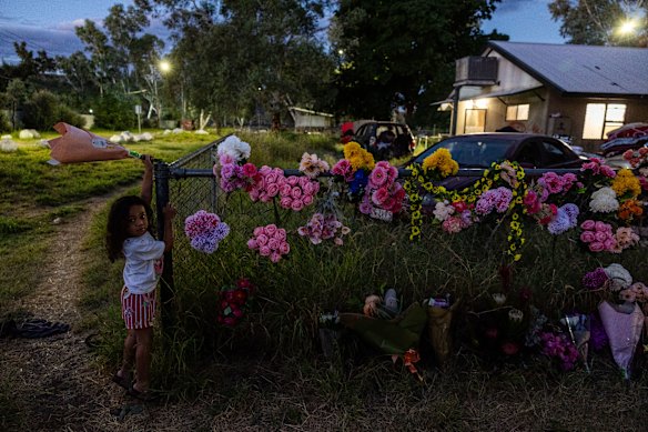 Hendricks Alosio lays a flower tribute  for Kumanjayi Little Baby at the old timers camp in Alice Springs, Northern Territory. Kumanjayi Little Baby was pronounced dead following a 6-day search.