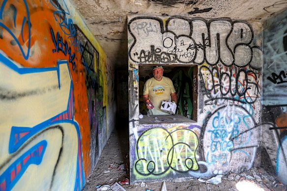 Roger Lloyd inside one of the graffiti-covered military structures on Point Lonsdale foreshore. Locals want the area’s history preserved.