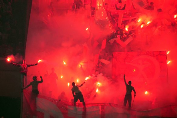 Hapoel supporters hold flares and chant during a Conference League playoff soccer match between Atalanta and Hapoel Tel-Aviv in Bergamo, Italy.