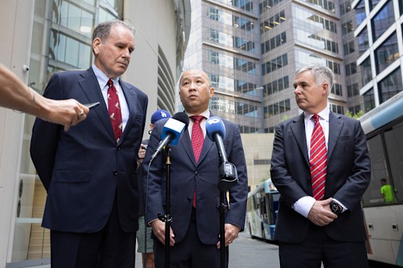 Optus chair John Arthur, Singtel CEO Kuan Moon Yuen, and Optus CEO Stephen Rue speak to media following a meeting with communications minister Anika Wells. 