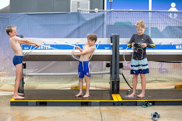 Henry, 10, and Toby, 7, McGarry from Faulconbridge hose off after a swim at Penrith Beach on a previous scorcher in early December.