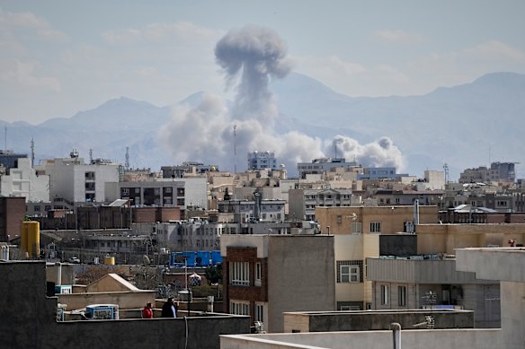 A plume of smoke rises after a strike in Tehran on Sunday.