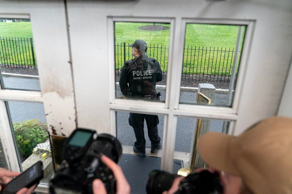 A member of the Secret Service guards the door of the press briefing room at the White House.