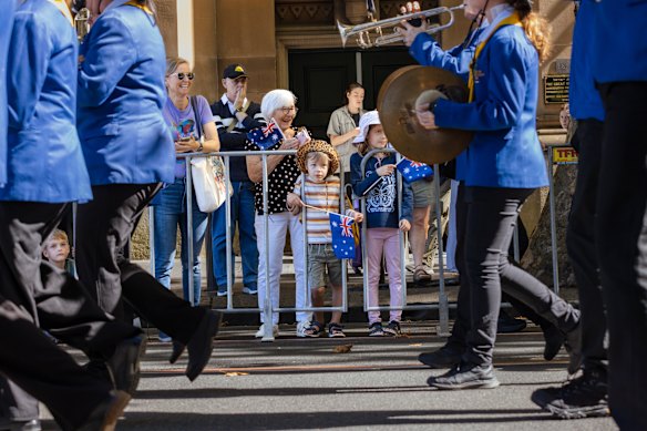 Spectators watch the Anzac Day march in Sydney.