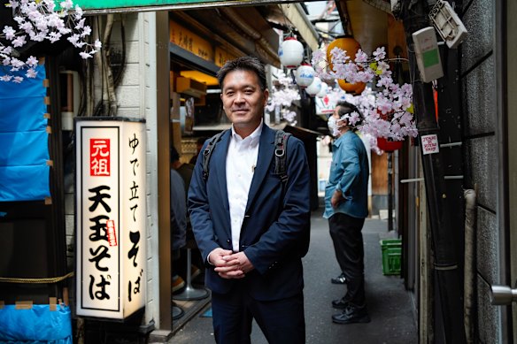  Office worker Makoto Nakamura outside a noodle bar in Tokyo.