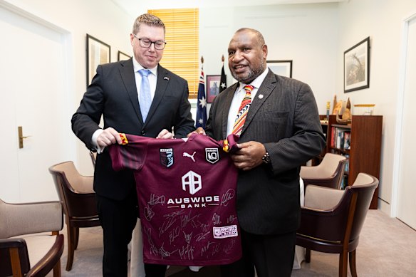 Pat Conroy presents a rugby league jersey to Papua New Guinea Prime Minister James Marape.