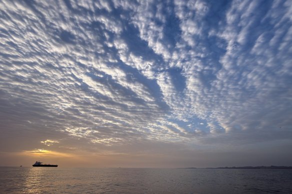 The sun rises behind a tanker anchored in the Strait of Hormuz off the coast of Qeshm Island, Iran.