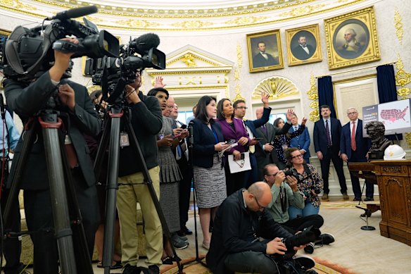 The White House press pack in the Oval Office in October.