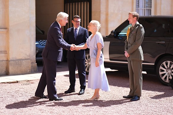 Sir Clive Alderton (left), the principal private secretary to the King and Queen, and King Charles III’s equerry, Major Ben Rigby (right), greet Burnham and his wife Marie-France van Heel at Buckingham Palace.