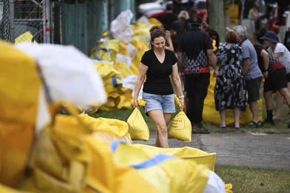 Residents collect sandbags from a council depot at Morningside on Monday.