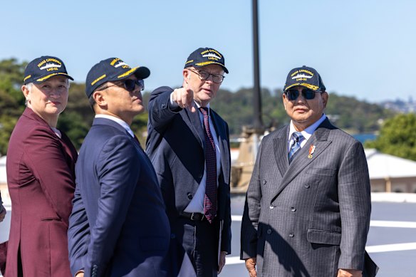 Foreign Minister Penny Wong, Indonesian Foreign Minister Sugiono, Prime Minister Anthony Albanese and Indonesian President Prabowo Subianto on the flight deck of HMAS Canberra on November 12.