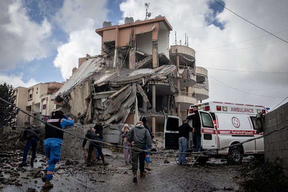 Paramedics and civilians rush to a building hit moments earlier by an Israeli airstrike in Nabatieh, Lebanon on Wednesday.