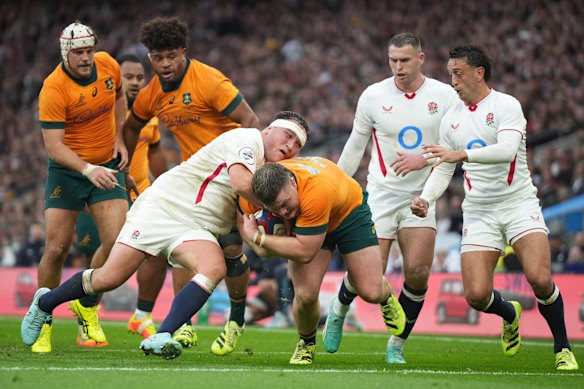 Australia’s Billy Pollard is tackled by England’s Jamie George.