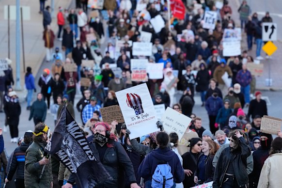 Protesters marching during a rally for Renee Good in Kansas City on Sunday AEDT.