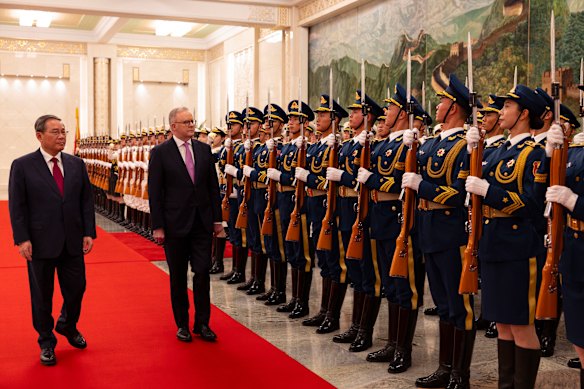 Chinese Premier Li Qiang and Prime Minister Anthony Albanese inspect troops before their formal meeting on Tuesday night.