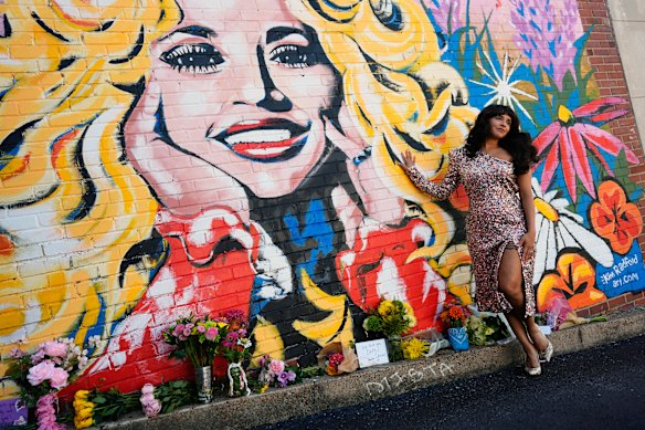 Singer Sunny Holiday poses for a photo near a mural of Dolly Parton in Nashville.