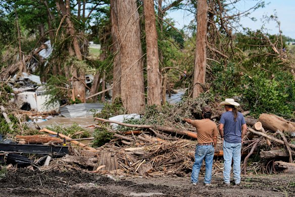 People survey the damage at Guadalupe Keys Resort, an RV park in Center Point, Texas.