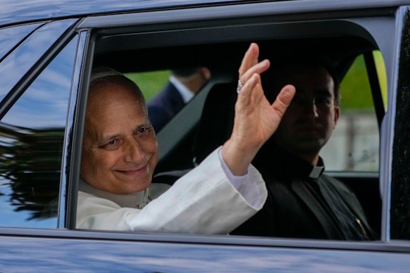 Leo waves to the crowd as he leaves Gemelli Hospital in Rome.