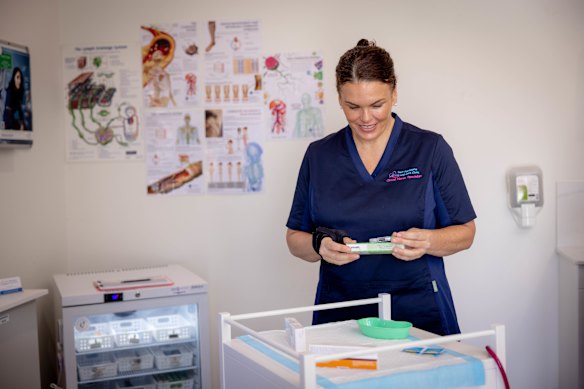 Nurse practitioner Melissa Freeman inspects the vaccines she can finally give patients after a two-year battle to remove legislation requiring vaccination centres to employ a GP. 