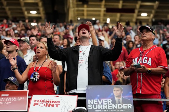 A man listens during a worship song before the start of a memorial for conservative activist Charlie Kirk.