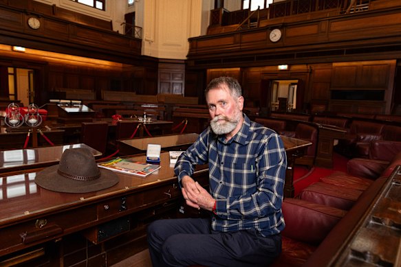 Barry Nash in the senate chamber in Old Parliament House in the seat vacated by Bert Milliner. His mother’s medal for 18 years of service at the telephone exchange is on the table.