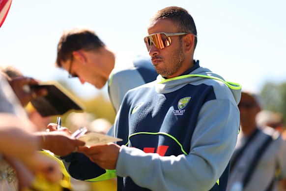 Usman Khawaja signs autographs on what should have been day three of the Boxing Day Test. 