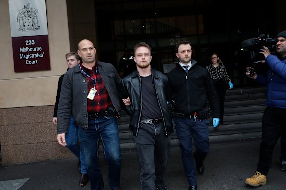 Police arrest a man outside Melbourne Magistrates’ Court.