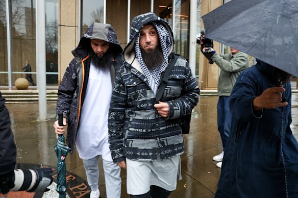 Wissam Haddad (centre) leaves the Federal Court in Sydney after a court found he contravened the Racial Discrimination Act in three lectures.