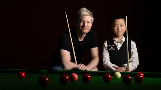 Neil Robertson with 11-year-old Austin Huang.
