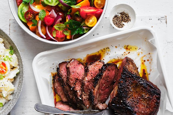 Barbecued lamb leg with tomato and mint.