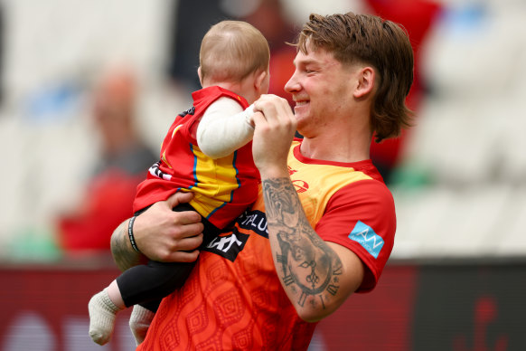 Bailey Humphrey of the Suns is seen with family on the MCG on Saturday.