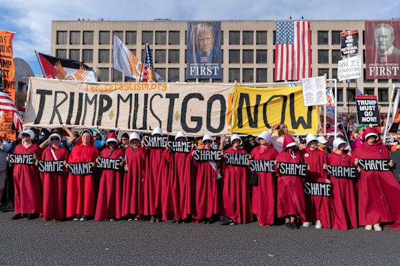 Demonstrators dressed as characters from The Handmaid’s Tale march to the US Supreme Court during a Trump Must Go Now rally. 
