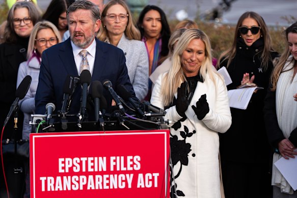 Marjorie Taylor Greene, right, attends a news conference on the Epstein files on Tuesday.