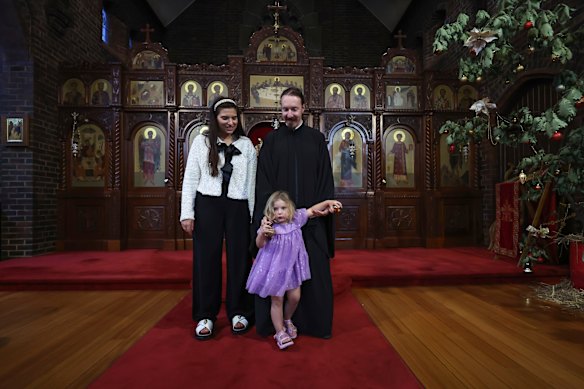 Priest Bogdan Milic inside Holy Trinity church in Brunswick East with his wife Radmila, and daughter Marta, 3.
