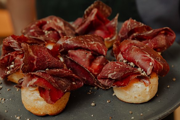 Jen Kwok Lee's party-ready crumpets topped with wagyu bresaola, egg yolk jam, and creme fraiche.