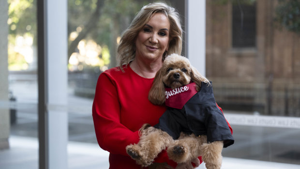 Gina Edwards and Oscar the cavoodle after she won her defamation case against Nine.