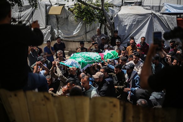 A funeral is held for Izz ad-Din al-Haddad, commander of Hamas’ military wing, and his wife and daughter at the Al-Aqsa Martyrs Mosque in Gaza City.