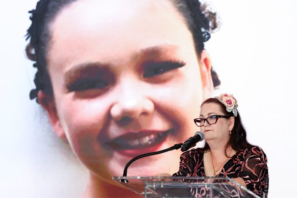 Emma Mason speaks in New York, with a picture of her 15-year-old late daughter Tilly behind her. 