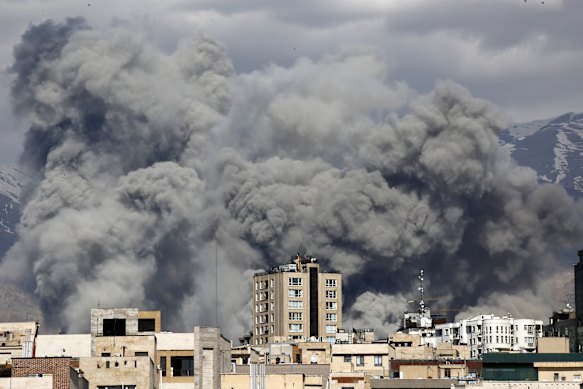 Smoke rises after an airstrike on Tehran on Sunday.