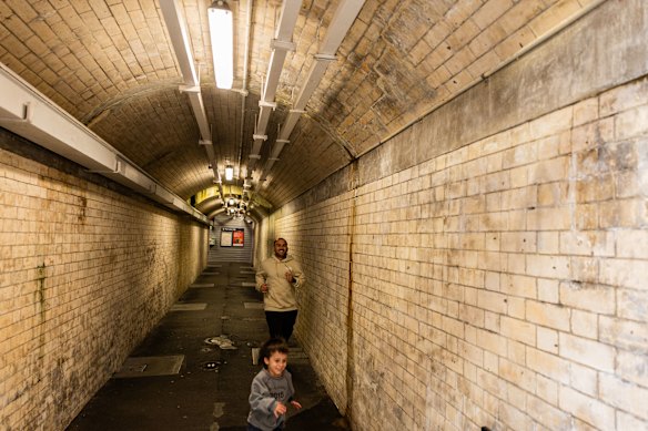 A boy leads the way through the tunnel at Macdonaldtown station.
