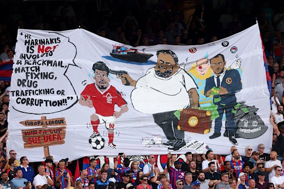 Fans of Crystal Palace hold up a banner on Sunday protesting against Nottingham Forest owner Evangelos Marinakis.