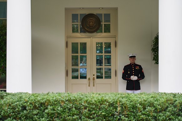 A US Marine stands guard outside the West Wing of the White House while Donald Trump has a meeting in the Situation Room on Tuesday (US time).