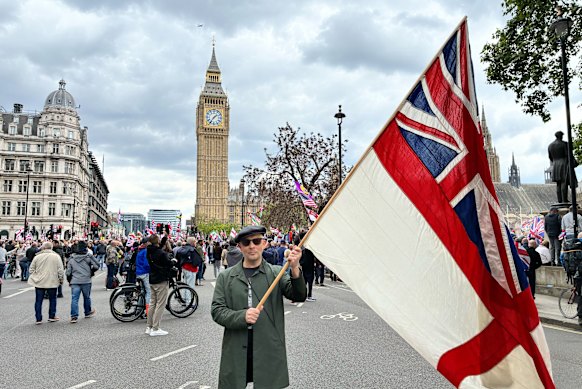 A supporter of lower migration waves a British naval ensign at the rally.