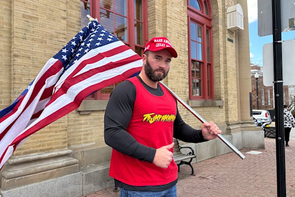 Trump supporter Jason Butler stood on the corner and blasted the Village People’s “YMCA” through a megaphone.