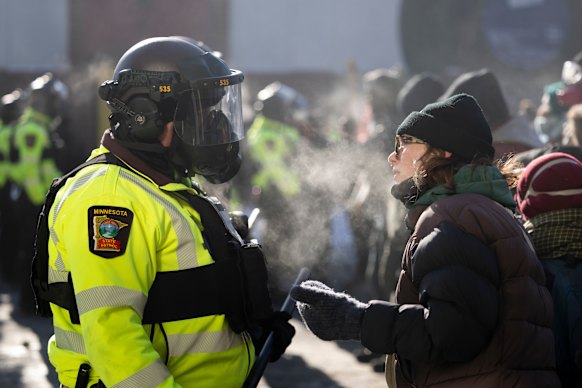 A protester speaks to a Minnesota State Patrol officer near the site of the fatal shooting of Alex Pretti.
