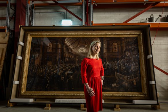 Dr. Michelle Stevenson (Head of History &amp; Technology, Museums Victoria) and the Charles Nuttall painting “The Opening, Commonwealth Parliament”
This weekend is the 125th anniversary of the opening of Australia’s Federal Parliament, which took place at the Royal Exhibition Building on May 9, 1901.
A key focus is the massive four-metre canvas by artist Charles Nuttall, which depicts the first sitting.