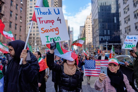 People hold signs in New York thanking US President Donald Trump for attacking Iran. 
