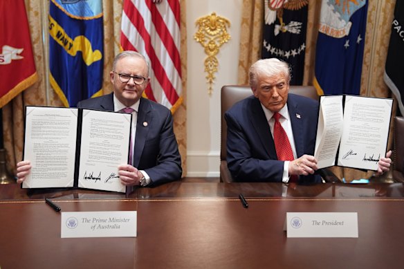 US President Donald Trump and Prime Minister Anthony Albanese hold up signed agreements on critical minerals and rare earths last month.  