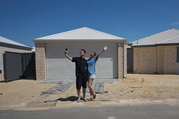 A shot from Harry Cunningham’s exhibition showing a couple celebrating their new home being completed.